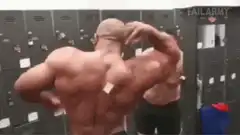 Bodybuilder flexes back in locker room