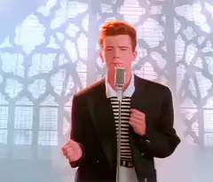 Rick Astley singing into a microphone