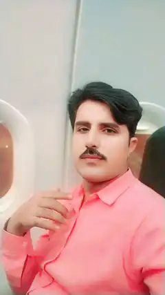 man in pink shirt on airplane