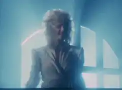 Tina Turner singing with arms raised