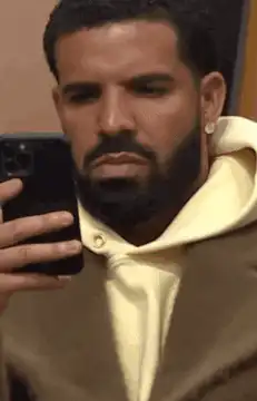 Drake looking at phone then tossing it