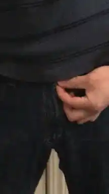 Hand zipping up jeans