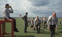 Prisoners doing pushups in the yard
