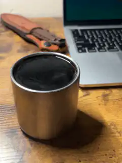 Coffee cup on desk with laptop
