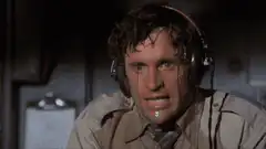 Man sweating profusely under headphones