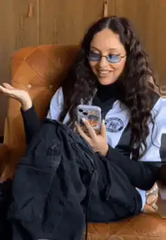 Woman laughing hysterically on couch