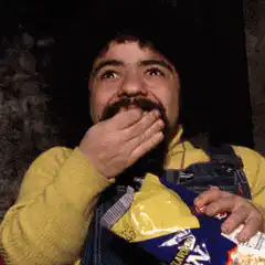 Man eating chips and smiling