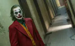 Joker in red coat hallway