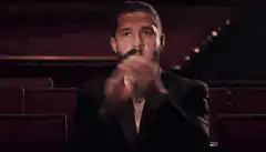 Man in tuxedo clapping