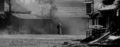 Man walking through dusty street