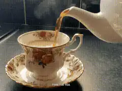 Tea being poured into a teacup