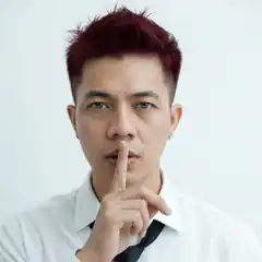 Man with red hair shushing
