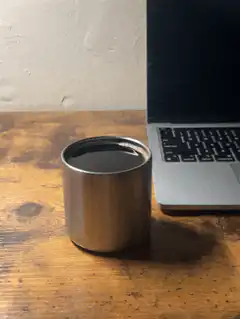 coffee cup next to laptop