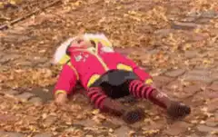Girl lying in autumn leaves