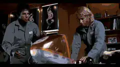 Two men lift a coffin lid