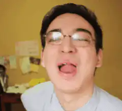 Man with glasses making funny faces