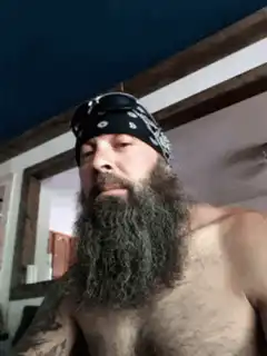 Bearded man touches his beard