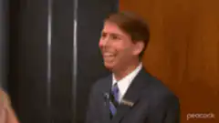 Man in suit laughing hysterically