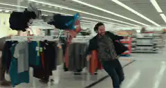 Man fighting a dog monster in a store