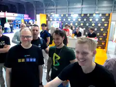 Group of men smiling at a tech conference