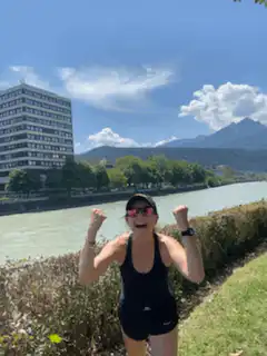 Woman celebrating outdoors by a river