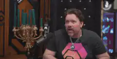 Dan Harmon clapping and looking up