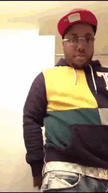 Man in colorful hoodie pulls out a knife