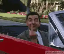 Mr. Bean flips off a car