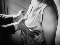 Hands unbuttoning striped shirt