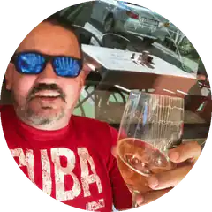 Man in sunglasses holding wine glass