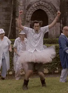 man in tutu jumping excitedly