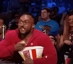 Man eating popcorn with mouth full