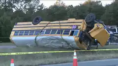 School bus flipped over then righted by tow truck