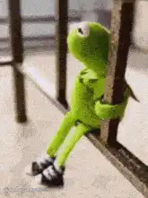 Kermit the Frog climbing a ladder