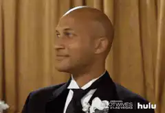 Man in tuxedo laughing hysterically