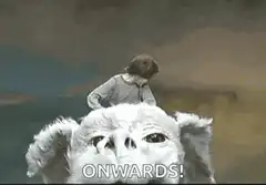 Boy riding pig shouting Onwards