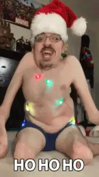 Man in Santa hat laughing with Christmas lights