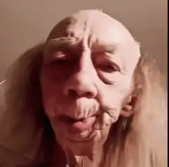 Old man with long hair smiling