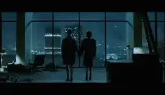 Two people watching a building explode