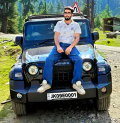 Man sitting on black Mahindra Thar