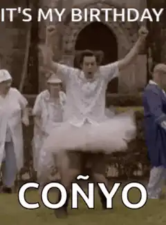 Man in tutu jumping with arms raised