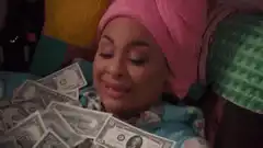 Woman in bathtub with money