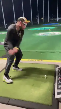 Man swings and misses golf ball
