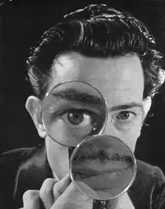 Man with magnifying glasses enlarging eyes