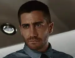 Jake Gyllenhaal winking and smirking