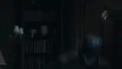 Batman and Catwoman in a dark room