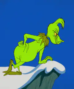 The Grinch leaning on a snowy cliff