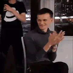 Man clapping with smug smile