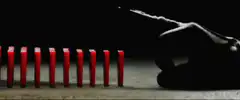 Red dominoes fall to form V for Vendetta symbol