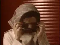 Woman puts on sunglasses
